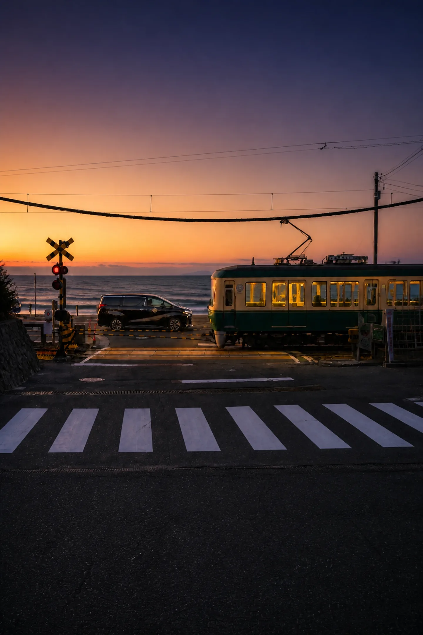 Octoshell private chauffeur vehicle beside the Enoden railway on the Shonan coast