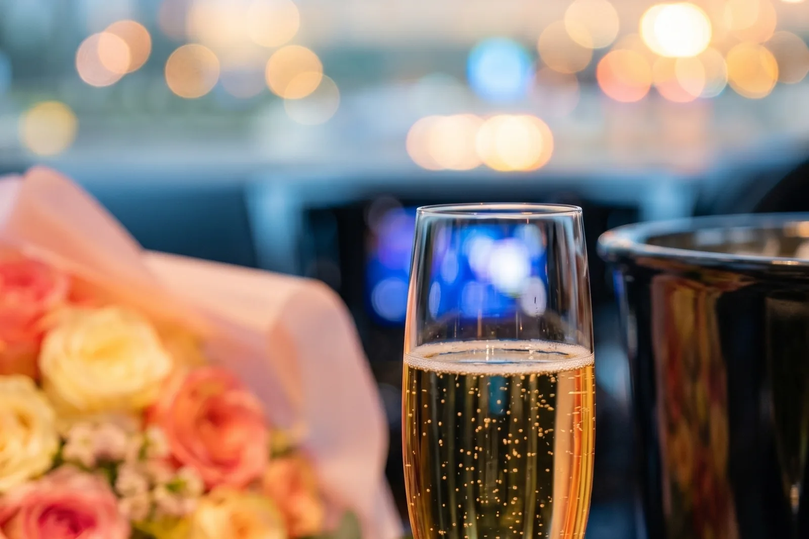 Champagne and flowers prepared beside a private ceremonial vehicle