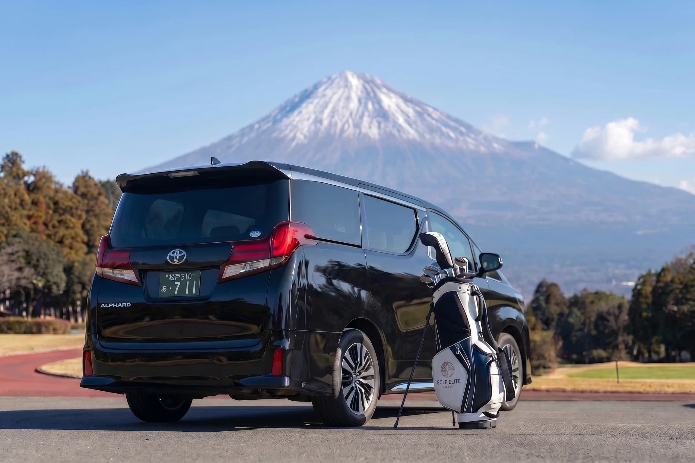 Toyota Alphard with golf bags at a course overlooking Mount Fuji
